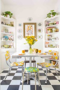 open kitchen shelving with dishes and bowls in bright dining room
