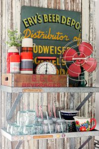 open kitchen shelving with bowls glasses and fan