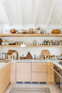 open kitchen shelving with mismatched wooden bowls