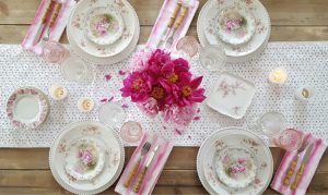 antique china sits a top a white table runner