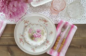 wood table white table runner and pink antique china