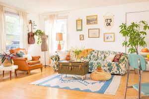 Vintage cottage living room with blue and green sofa, leather chair, and trunk coffee table