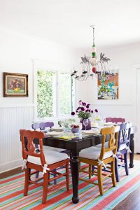 colorful dining room table and chairs with artwork