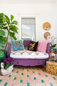 purple bench with colorful vintage pillows