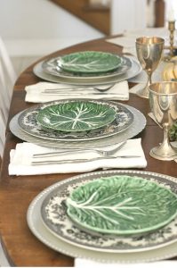 Vintage cabbageware plates layered over black and white transferware plates.