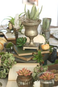 Stacks of vintage books add whimsey to the tables' decor and height to it's centerpieces