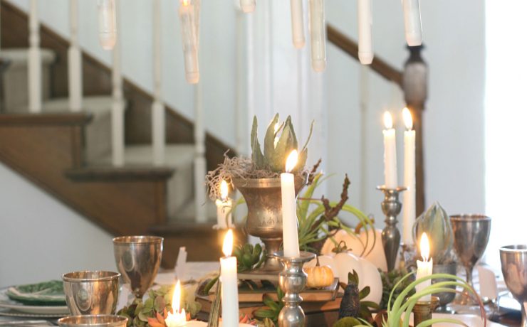 Candles floating over the elegant halloween tablescape add to the magic and mystery of the setting.