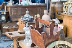 Piles of vintage and antique items at an estate sale