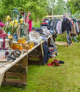 Vintage knick knacks and secondhand clothing at an outdoor estate sale