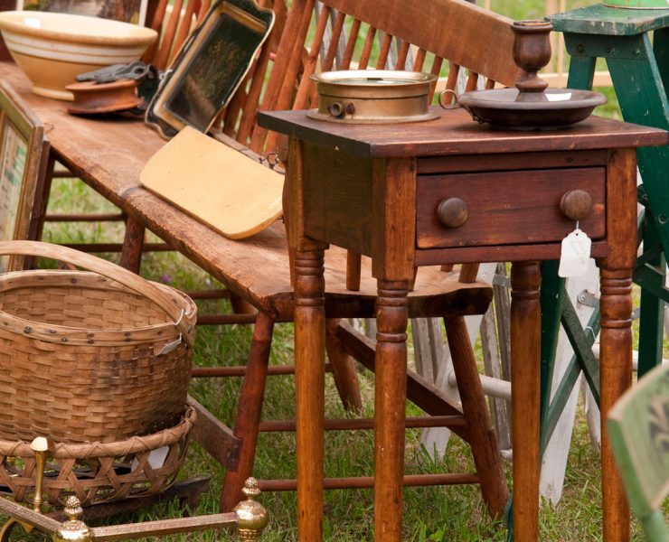 Wooden items at an estate sale including a bench, baskets, and a step stool