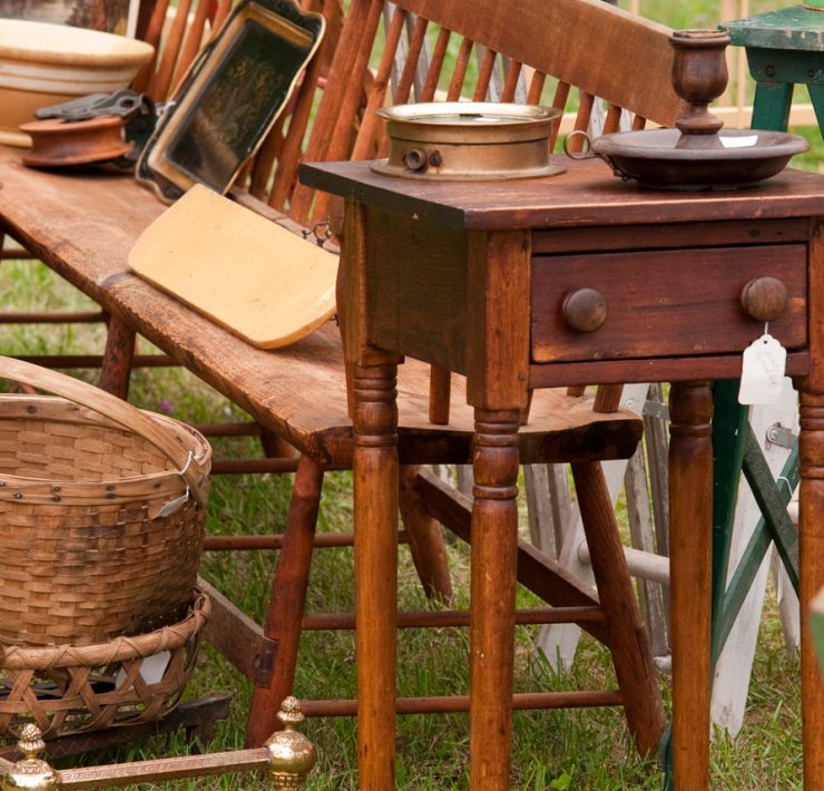 Wooden items at an estate sale including a bench, baskets, and a step stool