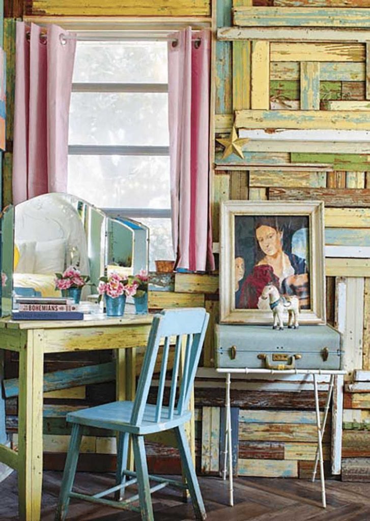 Vintage desk and portrait in front of a colorful DIY wood wall