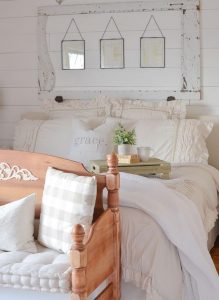 A bed draped in linen fabrics