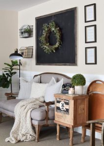 A couch made with muted tones beside repurposed industrial pieces