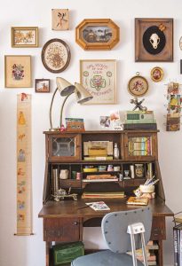 A 1920s "arts and crafts" style secretary desk, filled and surrounded with a slew of vintage fixtures.