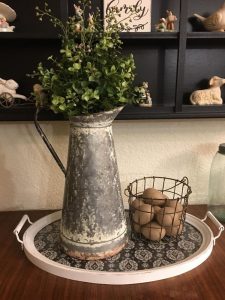 Galvanized metal pitcher with verdant greenery