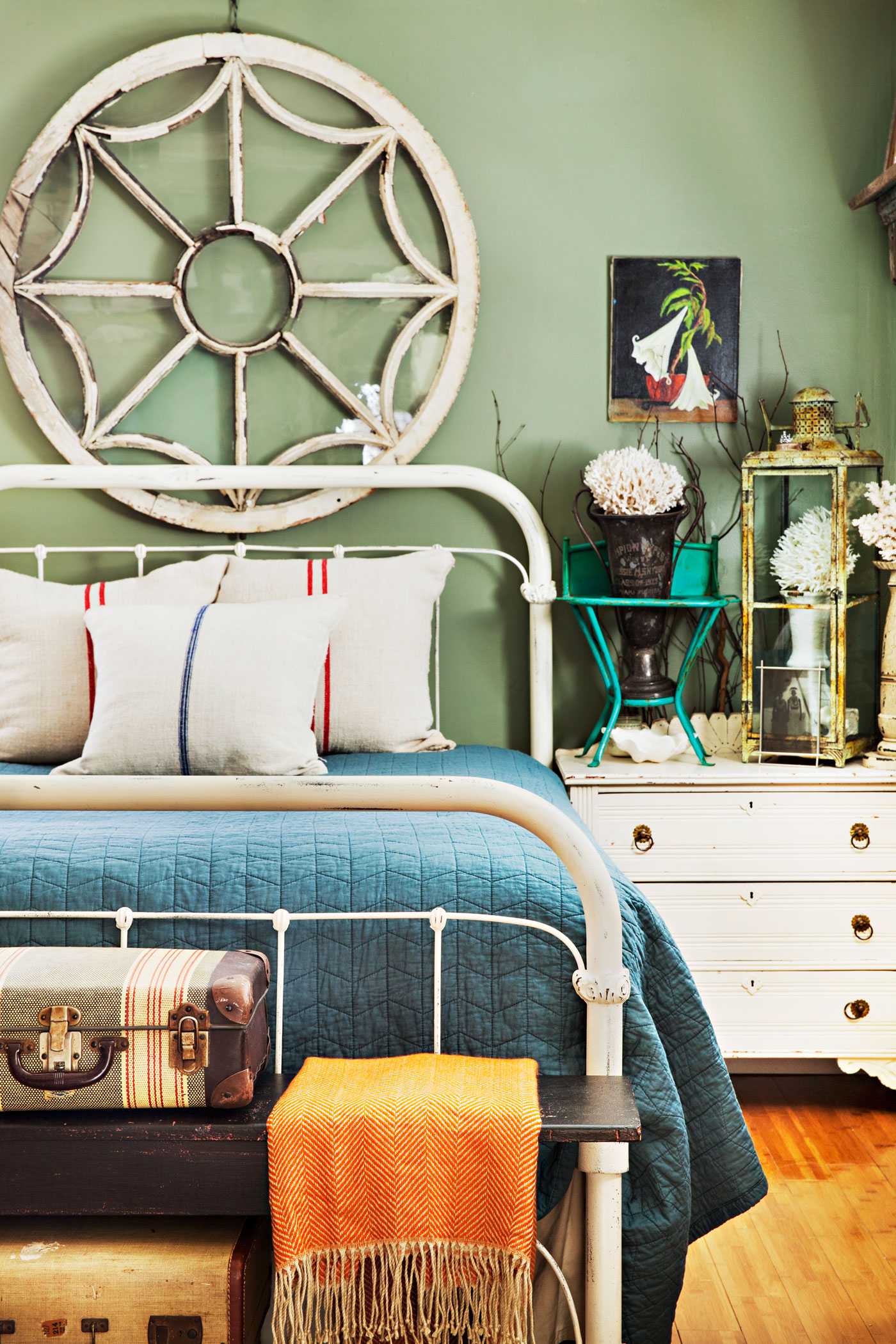 Bedroom with architectural salvage window hanging above the bedroom