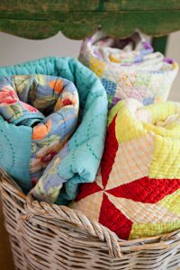 Basket of Vintage Quilts- How to Collect and Care for Quilts