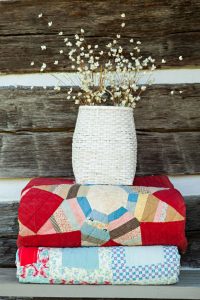 A stack of two vintage quilts. -How to Collect and Care for Quilts