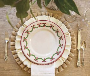 Christmas table setting with placemats, plates, and silverware