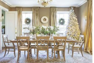 Farmhouse dining room decorated for Christmas with a white flocked tree
