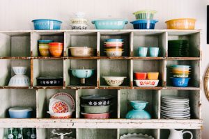 A collection of vintage Pyrex in antique shelving