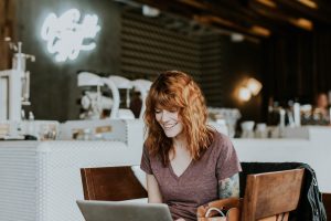 woman in cafe shopping safely online