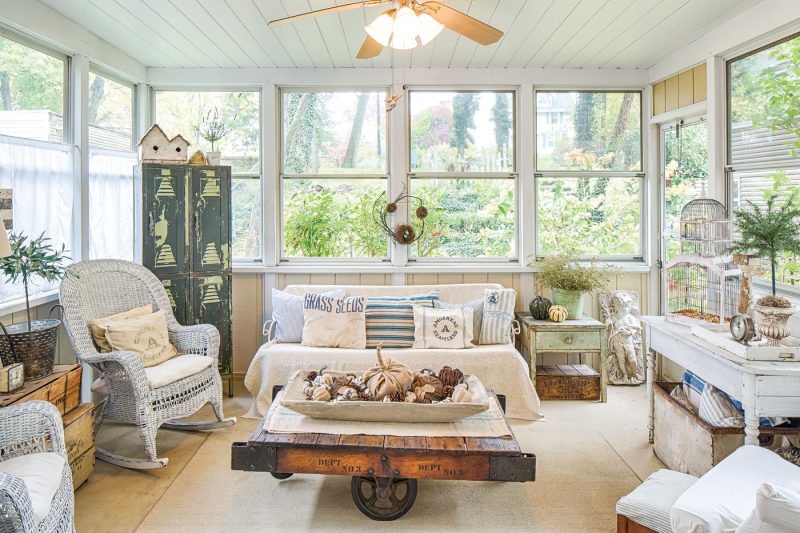 Sunroom with flea market collectibles and fall decor