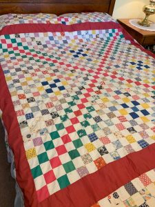 A classic among vintage quilts, this one has a multi-colored and patterned checkerboard pattern.