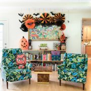 colorful chairs are featured in a family room decorated for a halloween party