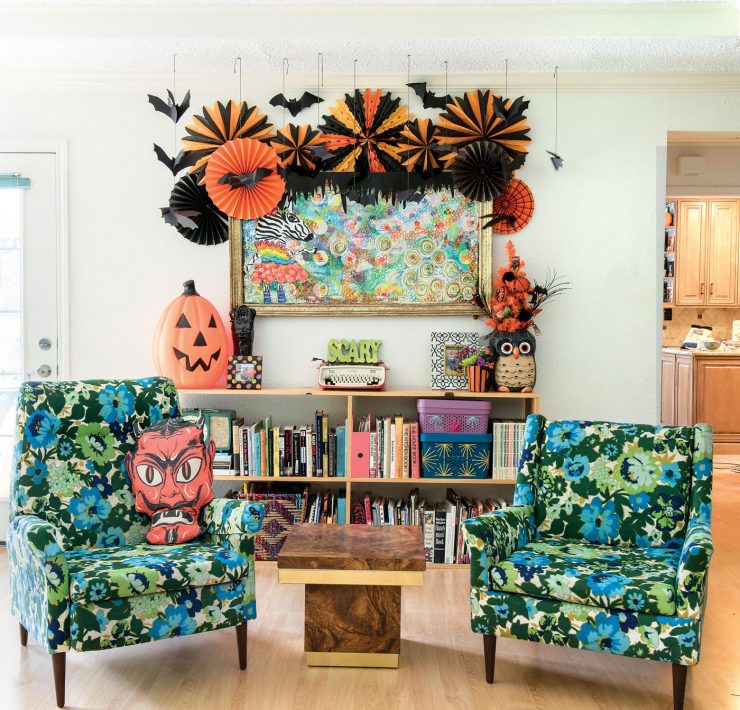 colorful chairs are featured in a family room decorated for a halloween party