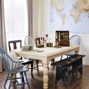 white table and mismatched chairs in sun drenched family room