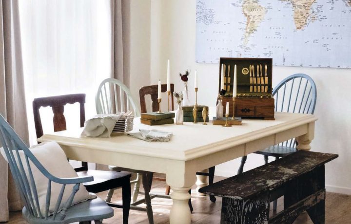 white table and mismatched chairs in sun drenched family room