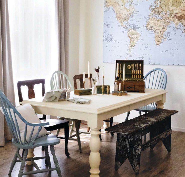 white table and mismatched chairs in sun drenched family room