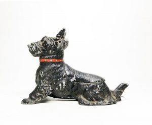 This vintage ash tray is a black Scottie dog with a red studded collar.