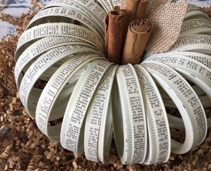 This faux pumpkin is made out of mason jar lids with strips of vintage text glued around them.