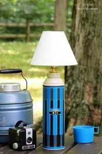 A vintage lamp with a thermos as its base.