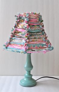 A vintage lamp engrossed in ruffled fabric scrap.