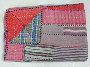 A simpler choice among vintage quilts, this quilt is made from rectangular strips of fabric bordered by stitched dots.