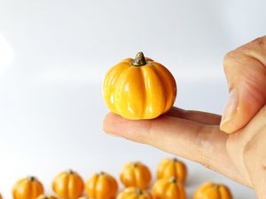 These faux pumpkins are mini orange ceramic pumpkins.