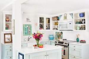 Kitchen with light blue cabinets and colorful accents