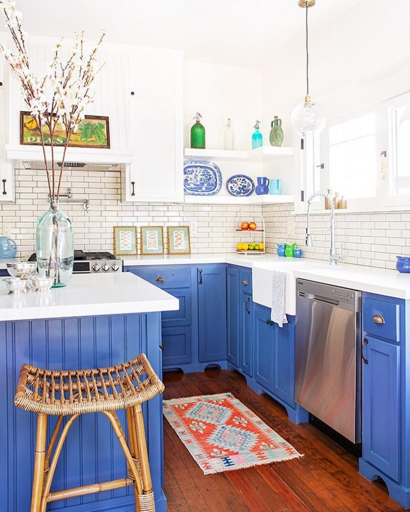 A kitchen scheme with dark blue cabinets balanced against white walls.