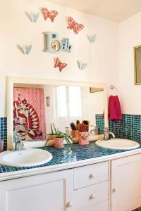 Vintage bathroom with original blue mosaic backsplash and Burwood "Bath" clock above the vanity