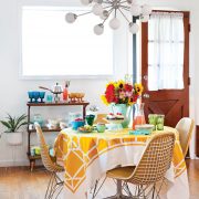 Sputnik chandelier above a Mid Century Modern table with a yellow tablecloth