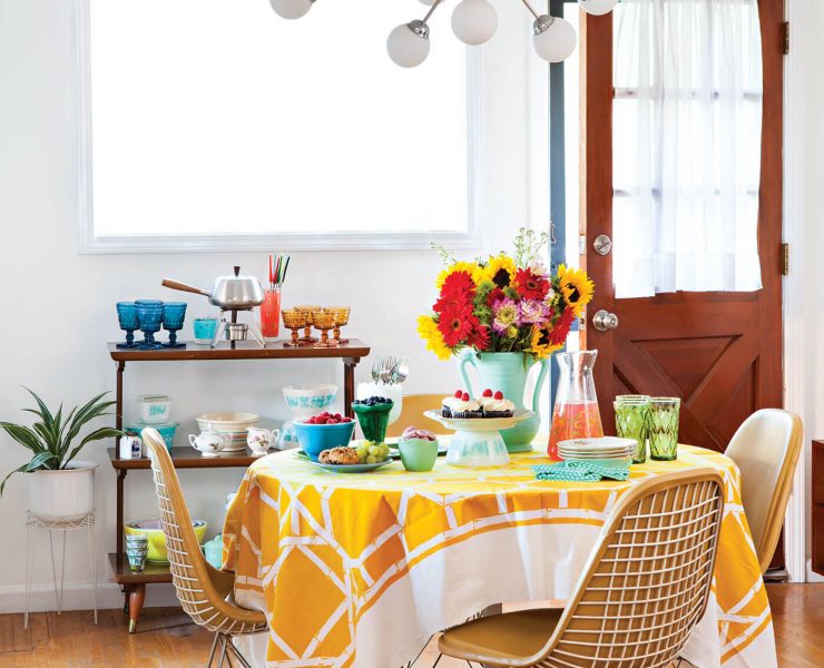 Sputnik chandelier above a Mid Century Modern table with a yellow tablecloth