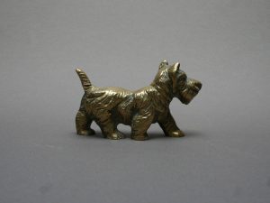 This miniature brass Scottie dog figurine is a perfect addition to a collection.