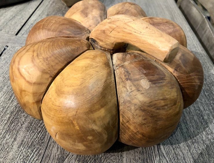 This pumpkin is hand carved from Teak wood.
