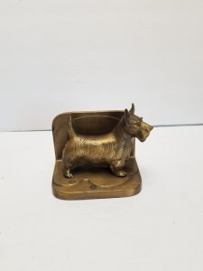 This brass Scottie dog bookend depicts the noble dog standing on all four feet.