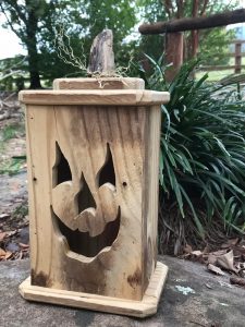 This rectangular, wood jack-o-lantern is made from reclaimed wood.