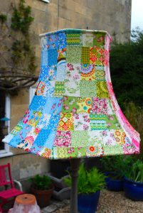 A lamp fashioned with a patchwork shade.